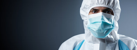 Medical specialist donning a PPE suit isolated on a gradient white backgroundの素材