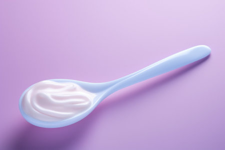 Whipped air-infused foam displayed on spoon isolated on a gradient backgroundの素材
