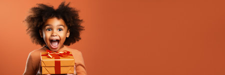 Surprised child opening holiday gift isolated on a gradient backgroundの素材