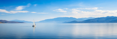 A Top Down Perspective of a Lone Sailboat Moored in a Tranquil Azure Cove with Space for Textの素材