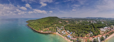 Panoramic aerial view of a lush tropical peninsula with clear blue waters, sandy beaches, and...