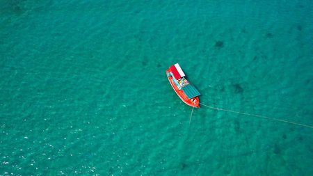 Aerial view of a fishing boat in the turquoise sea