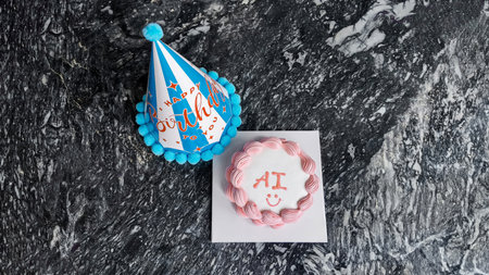 Birthday party concept with a festive blue party hat and a cake with AI lettering on a dark marbled...