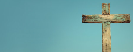Old wooden cross against a clear blue sky, suitable for religious concepts and Easter holiday themes with space for textの素材