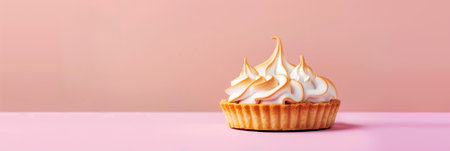 Cupcake with whipped cream on pastel pink background with copy spaceの素材