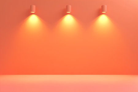 Warm orange abstract background with overhead lighting and gradient wall, ideal for product display or text placementの素材