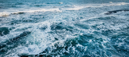 Dynamic ocean waves texture with vivid blue and white sea foam, suitable for backgrounds, marine...