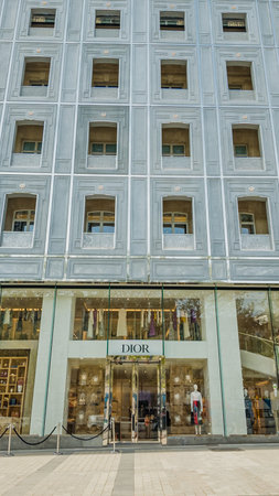 Dior flagship store facade with elegant design, shoppers entering, Paris, France, symbolizing luxury shopping and fashion industry, photographed on April 14th, 2024のeditorial素材
