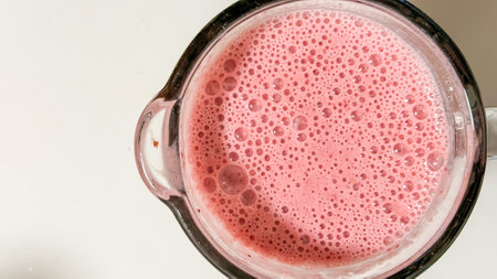 Foamy strawberry nectar in a glass pitcher, reminiscent of summer solstice indulgence, wellness elixir, and whimsical pink serenadeの写真素材