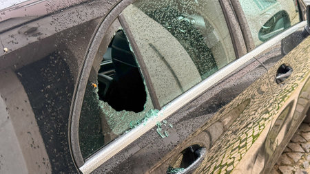 Shattered car window resembling urban crime scene, metaphor for chaotic Perchtenlauf, Celtic Samhain silence, unexpected winters breathの写真素材