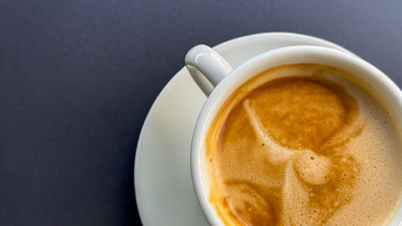 Foamy cappuccino in white ceramic, morning ritual of serenity, hygge vibesの写真素材