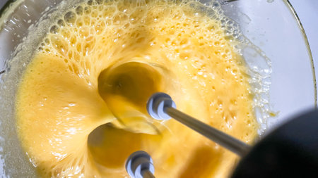 Whirlwind of foamy golden batter, kitchen alchemy for Pancake Day, quirkily resembling fluffy clouds, culinary magicの写真素材