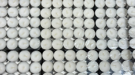 Rows of pristine tealights, a luminescent tapestry for Samhain rituals and Diwali celebrations, awaiting kindling flameの写真素材