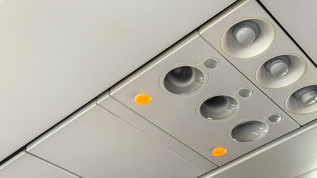 Illuminated buttons on an airplanes ceiling panel, evoking airborne odysseys, celebratory Flight Attendant Appreciation Day, aeronautical whimsyの写真素材
