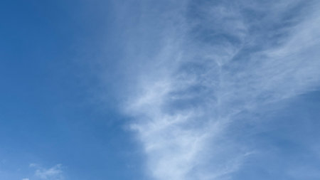 Whispering cirrus clouds dance across azure skies, celestial wanderings evoke contemplative serenity, akin to Tanabata or Cloud Appreciation Dayの写真素材