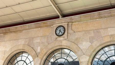Antique railway clock echoes times whispers, stone arches hold secrets of bygone journeys, resonating with Railway Heritage Day nostalgiaの写真素材