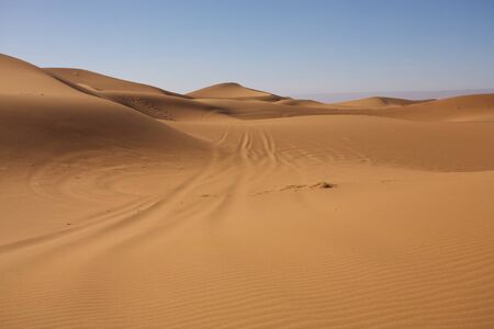 Sahara desert close to Merzouga in Morocco with blue sky and cloudsの写真素材