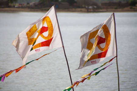 Mali flags floating with the Delta of Niger behind. For the 50th anniversary of its independanceのeditorial素材