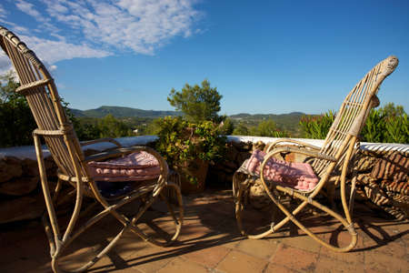 Relaxing time in Ibiza in rocking chairs with clear skyのeditorial素材