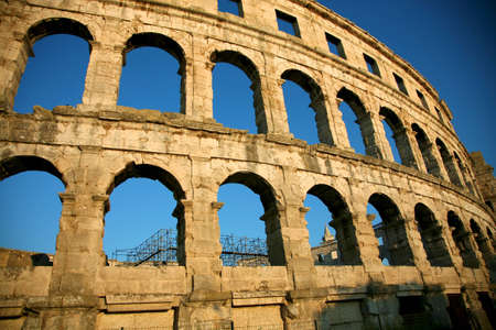 Arena of Pula in Croatia with a blue sky in the background and a nice sunset