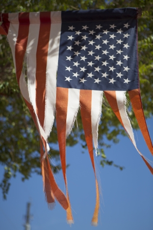 American destroyed flag in the windの写真素材