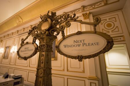 Hotel reception signs asking to go to the next window. Classical style.のeditorial素材
