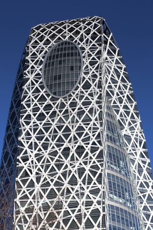 TOKYO, JAPAN - JANUARY 12, 2013: the Cocoon Tower in Shinjuku with a bluye sky in the background, Tokyo, Japanのeditorial素材