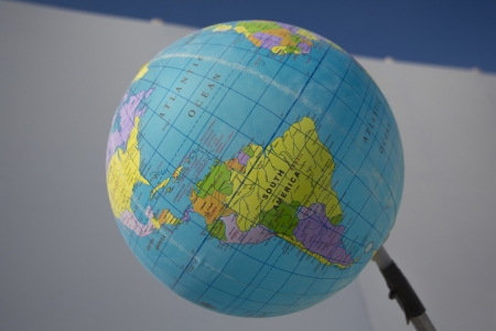 World globe with white background and blue sky の写真素材