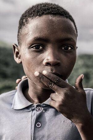 SOUTH AFRICA,COFFEE BAY, JANUARY 13 portrait on a Kids of A tribe village smiling to the camera with his finger on his month, near to Oribi Gorge Nature Reserve, January 13, 2007, South Africaのeditorial素材