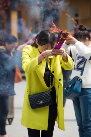 CHINA, SHANGHAI, APRIL 10: Unidentified group of people burning incense and praying in Shanghai, 10 April 2013.のeditorial素材