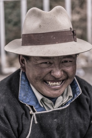 NEPAL, KATHMANDU, JULY 17: Portrait of an unidentified Tibetan man smiling and looking at the camera. There is a wide community of Tibetan people living in Kathmandu since the invasion of Tibet by China, July 17, 2013, Nepalのeditorial素材