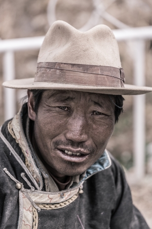 NEPAL, KATHMANDU, JULY 17: Portrait of an unidentified Tibetan man smiling and looking at the camera. There is a wide community of Tibetan people living in Kathmandu since the invasion of Tibet by China, July 17, 2013, Nepalのeditorial素材