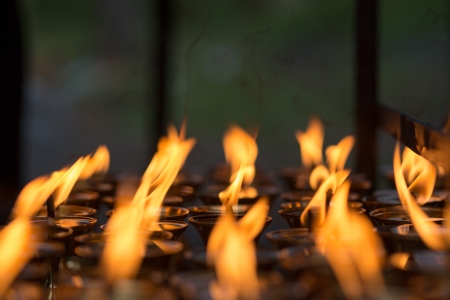 Burning candles in the famous Bouddanath temple in Kathmandu, which is one of the holiest Buddhist sites in Kathmandu, 20 April 2013.のeditorial素材