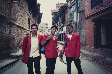 BHAKTAPUR, NEPAL, APRIL 24  Three unidentified Musicians in costume with their instrument posing in front of the camera after their session for a wedding  Nepal, 2013のeditorial素材