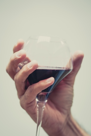 Soft hand with a glass of wine and a white background