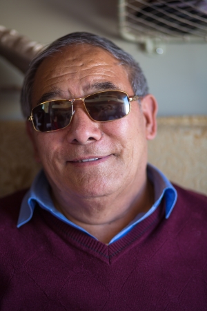 TIBET, CHINA, APRIL 15   unidentified Tibetan man with sunglasses travelling in the Train Shanghai to Lhasa, China 2013 のeditorial素材