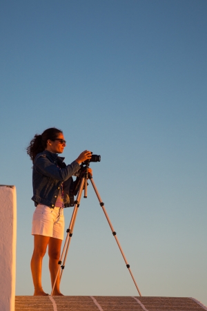 FOLEGANDROS, GREECE, JULY 23  Unidentified Woman taking a picture from the aegean sea in at sunset, Greece, 2013 のeditorial素材