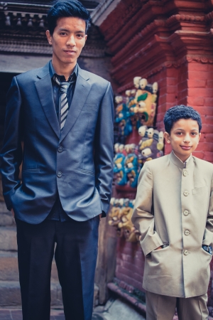 NEPAL, BHAKTAPUR, APRIL 24  unidentified Father and unidentified son posing in front of a traditional shop and dressed for a wedding, Nepal  2013, のeditorial素材