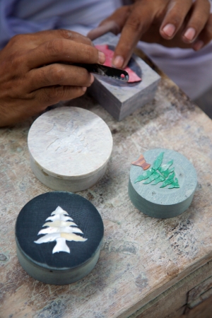 Hands of a craftsman working with soap stone products in Agra, India 2013.
