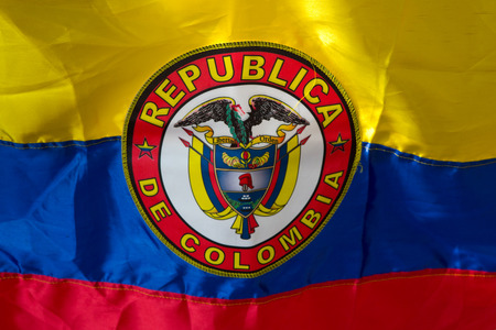 Close up of Waving Fabric Flag of Colombia, yellow red and blue.