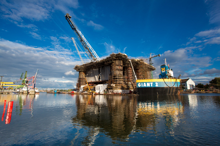 GDANSK, POLAND, SEPTEMBER 19: Docking oil rig at the Gdansk Shipyard under construction with a clear blue sky in the background. The oil rig weights 12 thousand tons. Gdansk, Poland, 2013のeditorial素材
