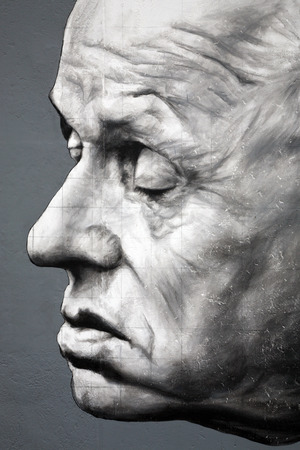 BERLIN - AUGUST 08: Famous graffiti of academician Andrei Sakharov on Berlin Wall at East Side Gallery August 08, 2009 in Berlinのeditorial素材