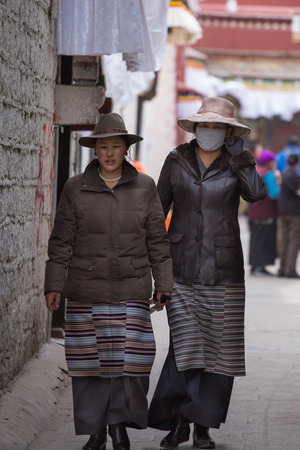 LHASA, TIBET, APRIL 16:  Unidentified  women walking in the old city of Lhasa in Tibet. The center of the old city is a UNESCO World Heritage site. China, 2013のeditorial素材