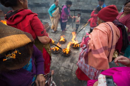 KATHMANDU, NEPAL, APRIL 24: Unidentified group of women burning sticks in Temple. Nepal, 2013.のeditorial素材