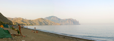 KOKTEBEL, UKRAINE, JULY 29: Unidentified naked people swimming and sunbathing at the city beach of Koktebel in Crimea on July 29, 2004, Ukraine. The beach is one of the most popular holiday resorts in Crimea, Ukraine.のeditorial素材