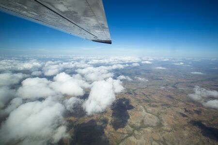 Aerial view of the land over the clouds and blue sky on the way to Ciudad Bolivar by small plane. Venezuelaの写真素材