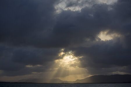 Dramatic cloud and sun light beams on the sea in Morrocoy National Park. Venezuelaの写真素材