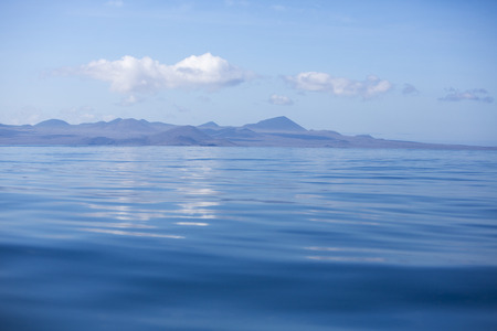 Rock formation in the middle of the Pacific Ocean in the Galapagos Islands against a clear blue sky. Ecuador 2015.の写真素材