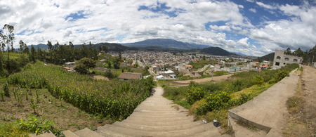 Panorama of the city of Otavalo and the surrounding mountains and volcano. Otavalo host one of the most important markets in the Andes, a weekly fiesta that celebrates the gods of commerce. Ecuador 2015.の写真素材