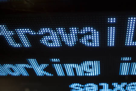 Led display with words travail and working with black backgroundの写真素材